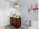 Bathroom with a wood vanity, framed mirror, and a flamingo-themed art piece at 13114 Long Common Pkwy, Huntersville, NC 28078