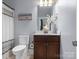 Bathroom features a vanity with a mirror and a toilet with a modern design at 13114 Long Common Pkwy, Huntersville, NC 28078