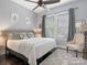Bedroom featuring a large bed, neutral decor, and plenty of natural light at 13114 Long Common Pkwy, Huntersville, NC 28078