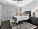 Bedroom with a dark wood bedframe, matching nightstands, and a striped area rug at 13114 Long Common Pkwy, Huntersville, NC 28078