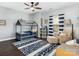 bedroom featuring a playhouse-style bed and a cozy sitting area with a striped rug at 13114 Long Common Pkwy, Huntersville, NC 28078