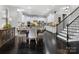 Open-concept with dark wood floors, white cabinets and a dining table in a brightly lit space at 13114 Long Common Pkwy, Huntersville, NC 28078