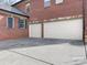 Beautiful brick home featuring an attached garage with multiple doors and dark shutters at 13114 Long Common Pkwy, Huntersville, NC 28078