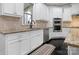 Bright kitchen features white cabinets, stainless steel appliances, and granite countertops at 13114 Long Common Pkwy, Huntersville, NC 28078