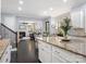 Open concept kitchen with granite island and stainless steel appliances leading into a living room with a fireplace at 13114 Long Common Pkwy, Huntersville, NC 28078