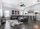 Spacious living room with dark wood floors, leather sofa, and modern ceiling fan at 13114 Long Common Pkwy, Huntersville, NC 28078