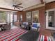 Covered porch with outdoor seating, ceiling fan, and an outdoor bar area at 13114 Long Common Pkwy, Huntersville, NC 28078