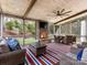 Screened-in porch featuring an outdoor fireplace and wicker furniture at 13114 Long Common Pkwy, Huntersville, NC 28078