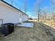 Side yard with newly laid straw, and air conditioning unit near a stone foundation and small patio at 1350 Russell St, Rock Hill, SC 29730