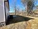 Side yard with newly laid straw, and air conditioning unit near a stone foundation at 1350 Russell St, Rock Hill, SC 29730