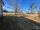 Side yard with newly laid straw, and scattered mature trees in the distance at 1350 Russell St, Rock Hill, SC 29730