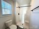 Bathroom with a sleek white shower, modern fixtures, a window, and a toilet at 1350 Russell St, Rock Hill, SC 29730