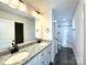 Bathroom featuring double sinks with granite counters, a large mirror, and a walk-in shower at 1350 Russell St, Rock Hill, SC 29730