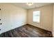 A bright bedroom is displayed with light-colored walls, wood-style flooring, and a window at 1350 Russell St, Rock Hill, SC 29730