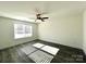 Light-filled bedroom with wood-look flooring, a modern ceiling fan, and large windows for natural light at 1350 Russell St, Rock Hill, SC 29730