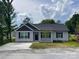 Charming single-story home featuring gray siding, black shutters, and a well-manicured front yard at 1350 Russell St, Rock Hill, SC 29730