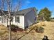 Side view of a single-story house with light gray siding, black shutters and green bushes at 1350 Russell St, Rock Hill, SC 29730