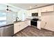 Bright kitchen featuring white cabinets, stainless steel appliances, granite countertops, and modern fixtures at 1350 Russell St, Rock Hill, SC 29730