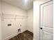 Laundry room with washer and dryer hookups, wood-look flooring, and a wire shelf for storage at 1350 Russell St, Rock Hill, SC 29730