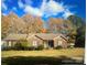 Charming single-story brick home featuring a well-manicured lawn and mature trees in a quiet neighborhood at 14818 Hooks Rd, Matthews, NC 28105