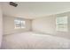 Spacious bedroom with neutral carpet, large windows, and ample natural light at 1705 Wooten Way, Bessemer City, NC 28016