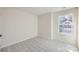 Bright bedroom features neutral walls, plush carpet, and a window offering natural light at 1705 Wooten Way, Bessemer City, NC 28016