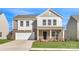Charming two-story home featuring a brick facade, attached garage, and well-maintained front lawn at 1705 Wooten Way, Bessemer City, NC 28016