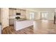 Open-concept kitchen with island, stainless steel appliances, and view of the living space at 1705 Wooten Way, Bessemer City, NC 28016