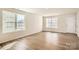 Bright and airy living room with hardwood floors and large windows, and a white front door at 1705 Wooten Way, Bessemer City, NC 28016