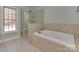 Luxurious bathroom boasts a large soaking tub and separate glass shower at 2100 Winding Oaks Trl, Waxhaw, NC 28173