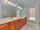 Bathroom features a double vanity, a large mirror, and a window at 2100 Winding Oaks Trl, Waxhaw, NC 28173