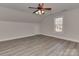 Neutral bedroom features gray flooring, a ceiling fan, neutral walls, and window at 2100 Winding Oaks Trl, Waxhaw, NC 28173