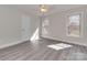 Bedroom featuring new vinyl flooring, fresh paint, and natural light at 2100 Winding Oaks Trl, Waxhaw, NC 28173
