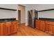 Modern kitchen with stainless steel refrigerator, granite countertops, and wood cabinets at 2100 Winding Oaks Trl, Waxhaw, NC 28173