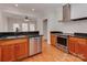 Modern kitchen with stainless steel appliances, granite countertops, and wood cabinets at 2100 Winding Oaks Trl, Waxhaw, NC 28173