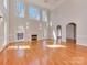 Bright open living room with fireplace, hardwood floors, and high ceilings at 2100 Winding Oaks Trl, Waxhaw, NC 28173