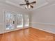 Bright living area features hardwood floors, recessed ceiling, and glass doors to the outdoors at 2100 Winding Oaks Trl, Waxhaw, NC 28173