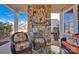 Inviting back porch with stone fireplace and wicker furniture, perfect for relaxing outdoors at 2172 Paddlers Cove Dr, Clover, SC 29710