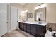 A bathroom features double sinks, a granite countertop, and a tile floor, with stylish hardware at 2172 Paddlers Cove Dr, Clover, SC 29710