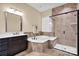 A soaking tub and glass-enclosed shower enhance this bathroom with stylish tilework and a modern vanity at 2172 Paddlers Cove Dr, Clover, SC 29710