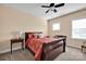 A serene bedroom featuring a wooden bed frame, complementing furniture, and natural light from the window at 2172 Paddlers Cove Dr, Clover, SC 29710