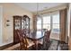 Elegant dining room with a wooden table, ornate china cabinet, and natural lighting at 2172 Paddlers Cove Dr, Clover, SC 29710
