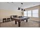 A game room boasts a pool table, couch, and bar stools perfect for entertaining and leisure at 2172 Paddlers Cove Dr, Clover, SC 29710