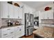 Well-equipped kitchen boasts granite countertops, stainless steel refrigerator, and built-in microwave at 2172 Paddlers Cove Dr, Clover, SC 29710