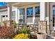 Inviting covered porch with stone pillars, rocking chairs, and colorful landscaping at 2172 Paddlers Cove Dr, Clover, SC 29710