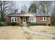 Quaint brick home with gray shutters, a well-kept lawn, and a welcoming front porch at 3039 N Center St # 10/C, Hickory, NC 28601