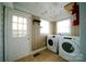 Functional laundry room including a washer, a dryer, and an exterior door at 3039 N Center St # 10/C, Hickory, NC 28601