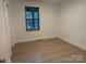 Bedroom features window with blinds, hardwood floors and closet at 3332 Draper Ave, Charlotte, NC 28205