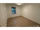 Minimalist bedroom with hardwood floors and a window at 3332 Draper Ave, Charlotte, NC 28205