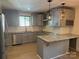 Modern gray kitchen featuring granite countertops, stainless steel appliances, and stylish pendant lighting at 3332 Draper Ave, Charlotte, NC 28205